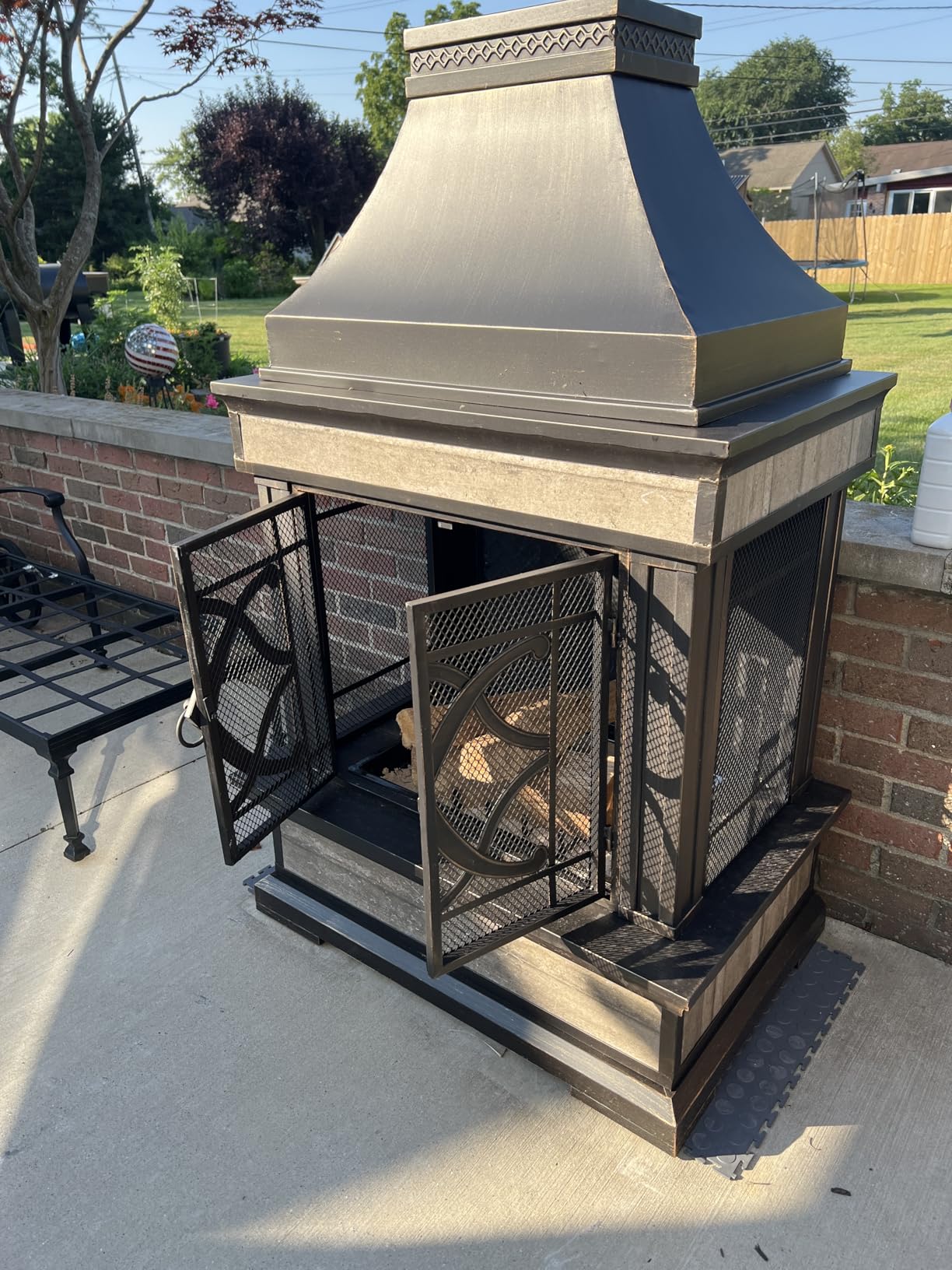 Sunjoy Outdoor Fireplace, Stone Look Tile Patio Wood Burning Steel Fireplace with Chimney, Spark Screen, Fire Poker, Rain Cover, and Removable Grate, Black with Golden Highlight customer photo 2